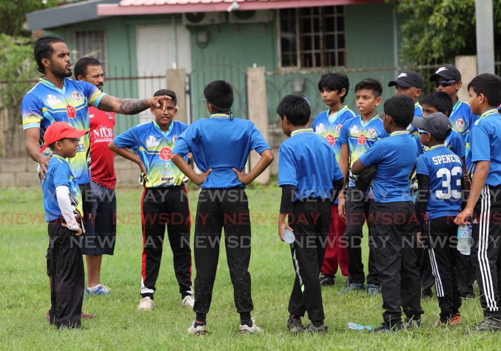 Central Sports captain and national player Kjorn Ottley holds the attention of his young charges in the Chaguanas West Constituency Cricket Camp. - 