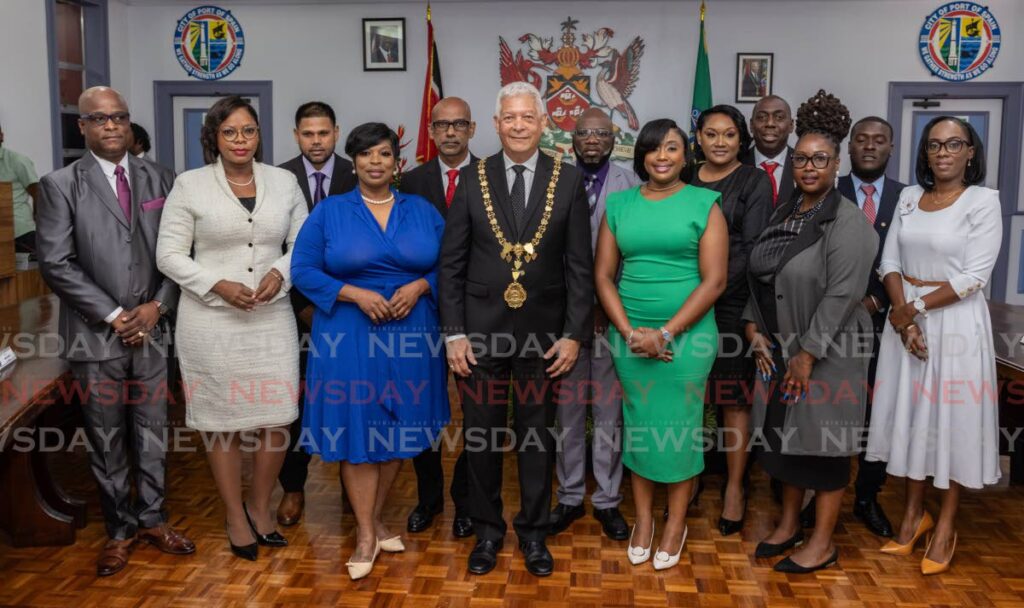 Newly sworn in councillors of the Port of Spain City Corporation with the outgoing Mayor Joel Martinez, centre, at a swearing-in ceremony at City Hall on Friday. - Jeff K. Mayers