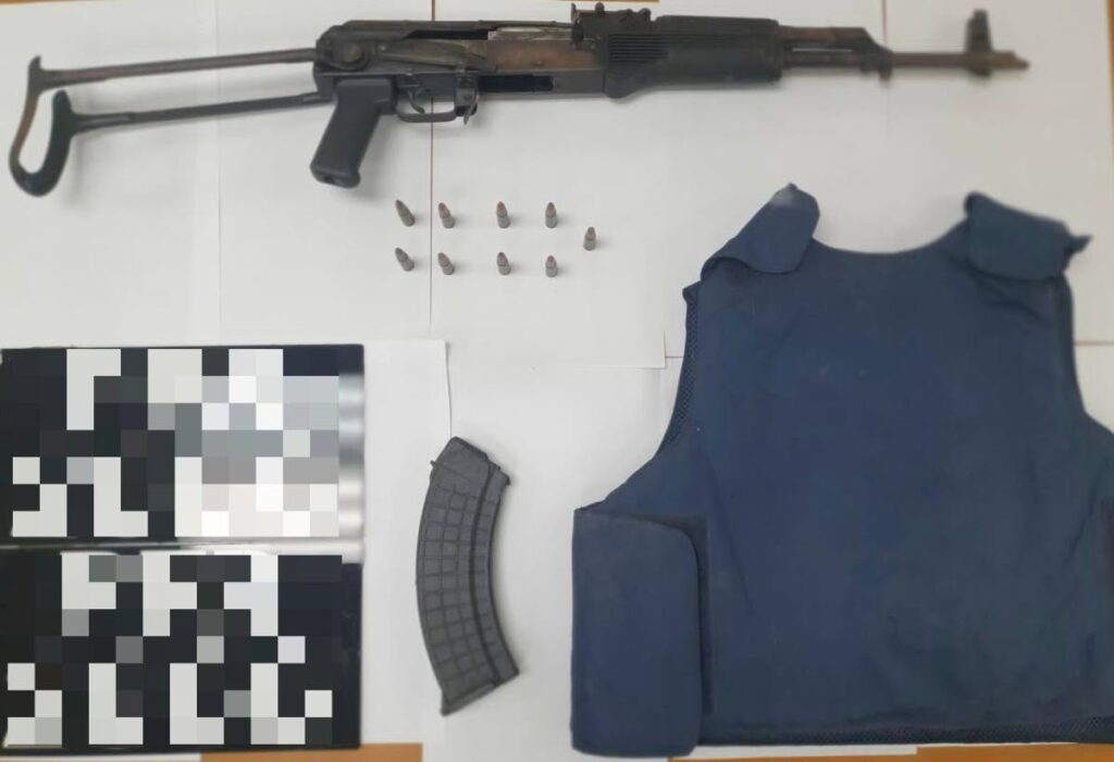An Ak-47 rifle, ammunition and a bullet-proof vest were recovered by police in Malick on Friday. - Photo courtesy TTPS