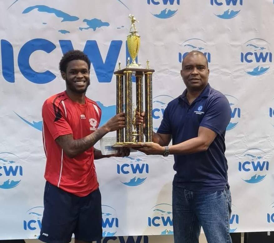 Aaron Wilson, left, collects his cash prize and trophy from ICWI Country General manager Lochinvar Lungren. - 