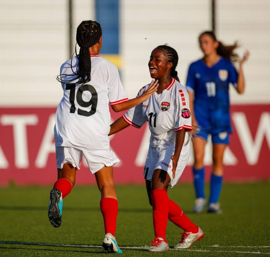 TT's Daneelyah Salandy, left, celebrates a goal with her teammate against Cayman Islands in the Concacaf Women's Under-17 Championship, at the Rignaal Jean Francisca stadium, in Willemstad, Curaçao, Monday. PHOTO COURTESY CONCACAF - 