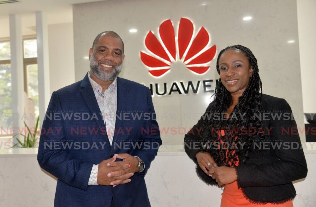 Tudor John, enterprise business director (left) and Tricia Henry PRO at the Huawei TT office in Port of Spain on August 15. - Photo by Anisto Alves