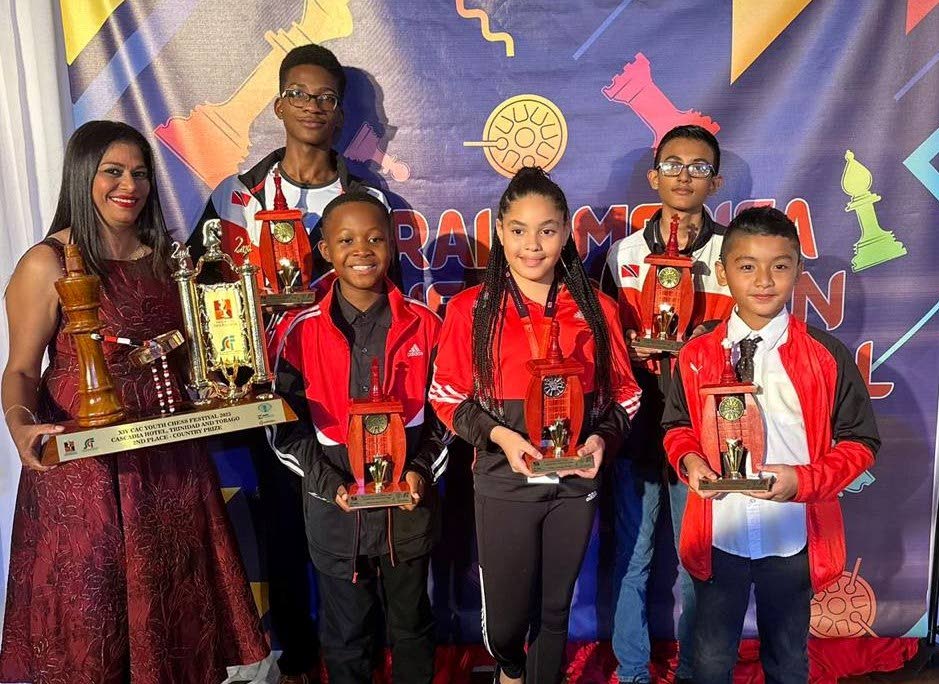 Trinidad and Tobago's players at the CAC Youth Chess tournament are presented with their medals and trophies.  - 