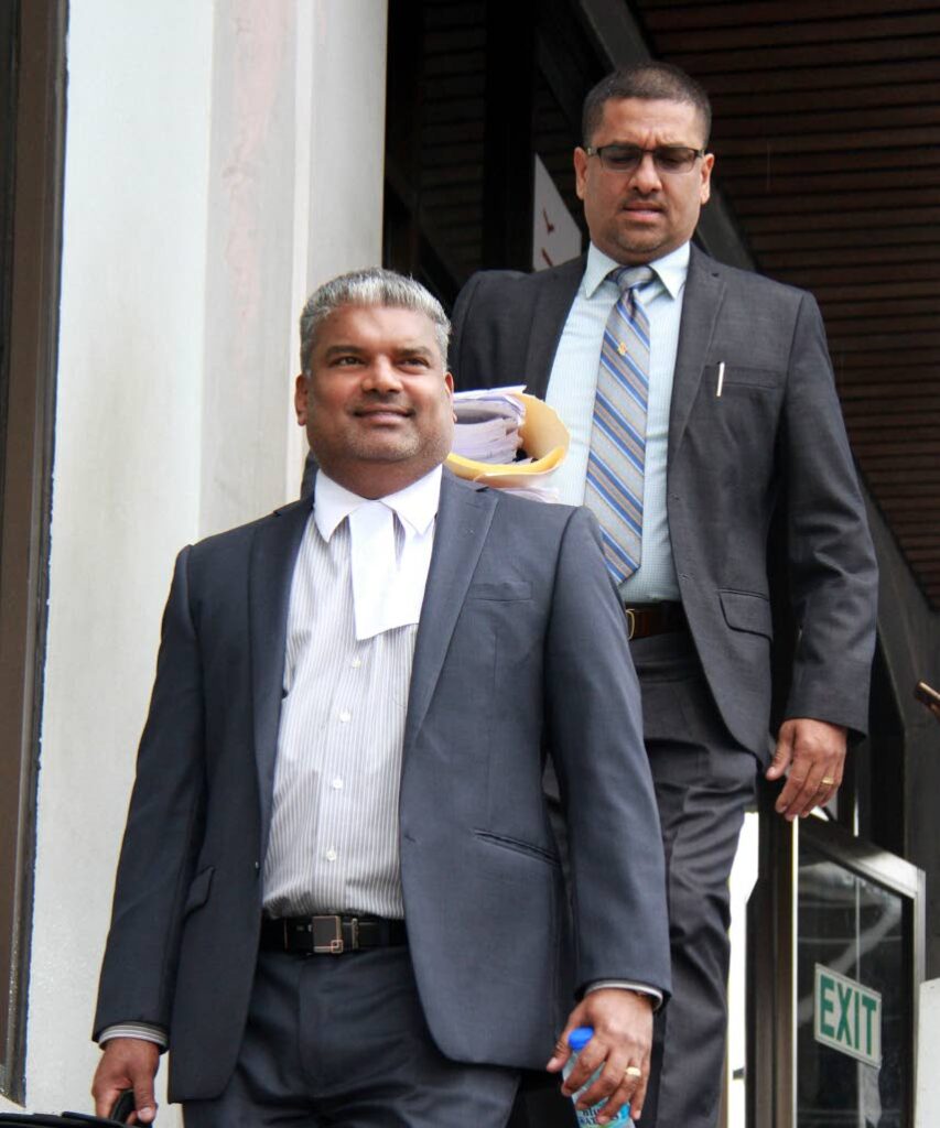 At right, acting Sgt Billy Ramsundar leaves the San Fernando High Court in company with his attorney SC Anand Ramlogan. Ramsundar brought a judicial review matter against acting police commissioner Stephen Williams on failing to promote.
PHOTO BY ANIL RAMPERSAD. 