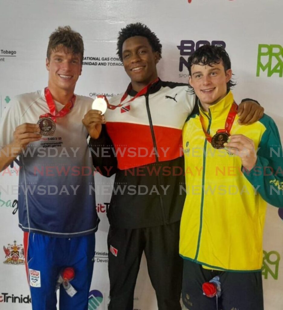 Trinidad and Tobago's Nikoli Blackman, centre, with his gold medal after winning the men's 200m freestyle at the Commonwealth Youth Games, National Aquatics Centre, Couva, Sunday. Blackman is flanked by runner-up James Allison of Cayman Islands, left, and third-placed Australian Harvey Larke. Photo by Jonathan Ramananansingh