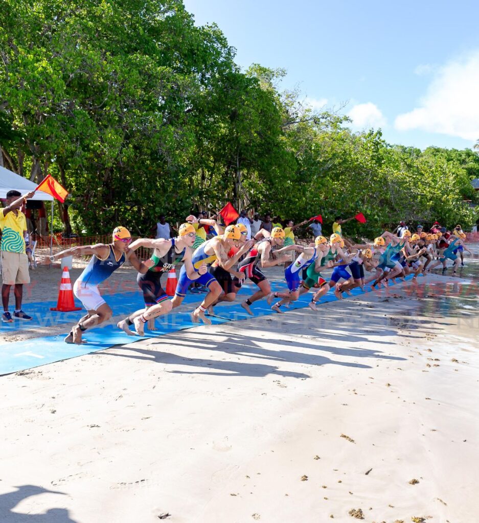 Athletes race to the water to begin the Mixed Team Relay Super Sprint Distance during the 2023 Commonwealth Youth Games, on Tuesday, at the Buccoo Beach Facility.