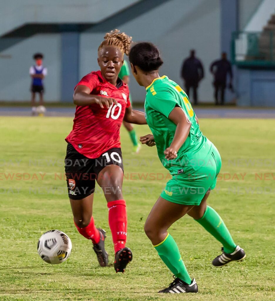 In this April 12, 2022 file photo, TT’s Asha James (L) controls the ball against a Guyana senior women’s player during the Concacaf World Cup qualifier, at the Dwight Yorke Stadium, Bacolet. - David Reid