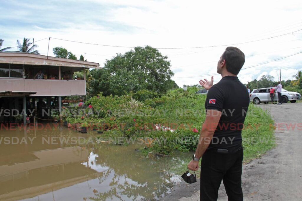 In this file photo, Local Government and Rural Development Minister Faris Al-Rawi tours Seuradge Trace, Debe, which was affected by flash floods in 2022. - 