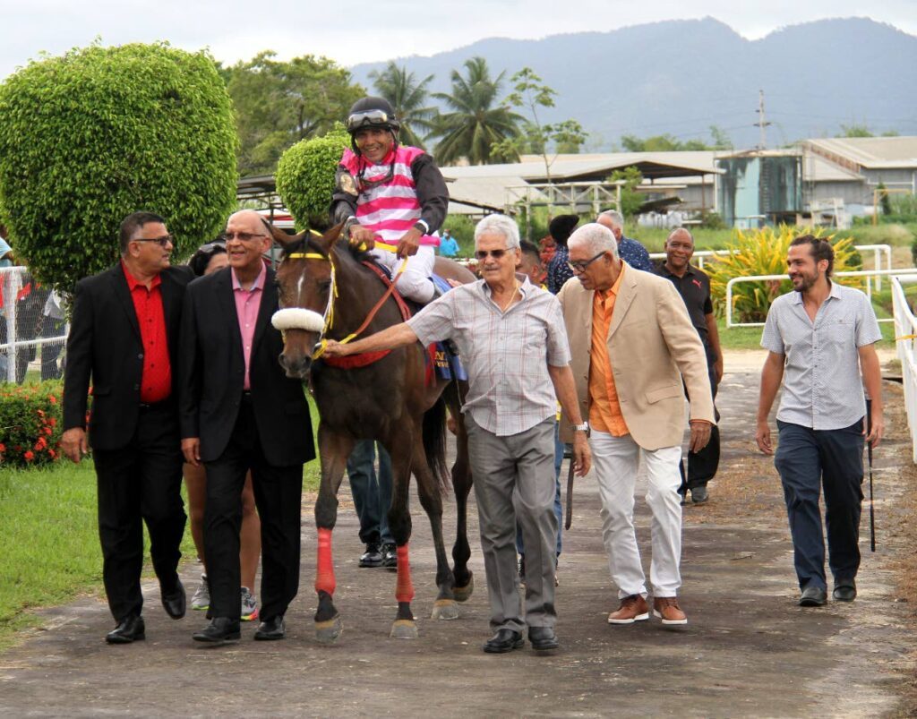 In this file photo, Soca Harmony, with veteran jockey Nobel Abrego aboard, is led to the winner's circle by her handlers after winning the Carib Trinidad Derby Stakes, on the Republic Day racing, at the Santa Rosa Race Park, Arima, on September 24, 2022. - AYANNA KINSALE