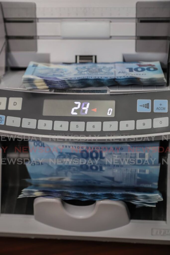 A stack of $100 bills being run through a money counter.
File Photo - JEFF K MAYERS