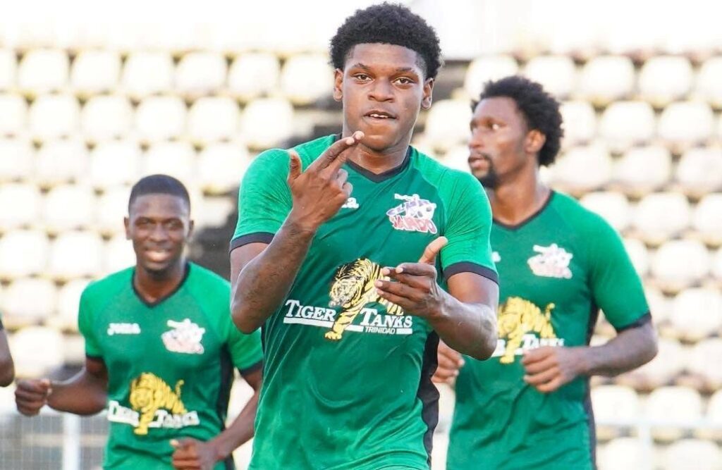 Nathaniel James, centre, celebrates a goal for Club Sando last season in the TT Premier League.  - TT Premier Football League 