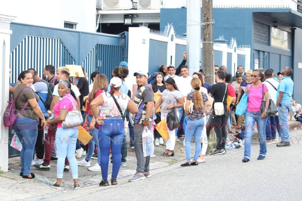 In this file photo, Venezuelans deliver their documents for renewal of their work permits to the Immigration Office. - 