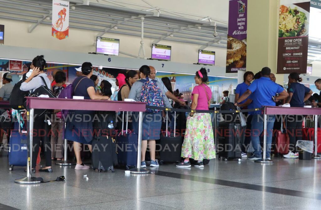 In this file photo, Caribbean Airlines passengers wait for information at Piarco International Airport on August 21, after several flights were cancelled after pilots called in sick.  - Angelo Marcelle