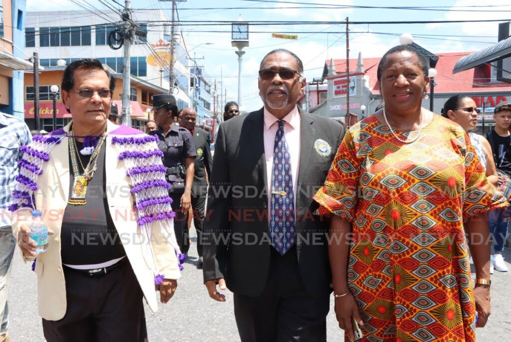 Arima Mayor-Elect Balliram Maharaj, out-going Arima Mayor Cagney Casimire and Arima MP Pennelope Beckles-Robinson, partake in the annual Santa Rosa Festival procession, through the streets of Arima.  - Photo by Angelo Marcelle