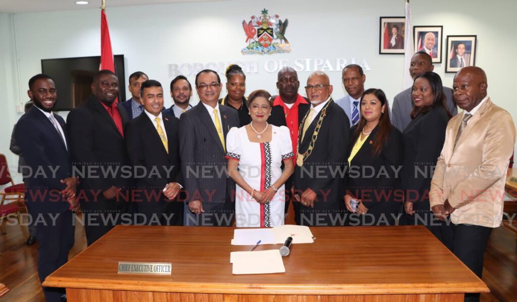 Opposition Leader Kamla Persad-Bissessar, flanked by newly sworn in Mayor Of the Borough of Siparia Alderman Doodnath Mayrhoo on right and Deputy Mayor Shankar Teelucksingh on left at the swearing-in ceremony for alderman and a Mayor at the  Siparia Borough Corporation on Wednesday. - Photo by Angelo Marcelle