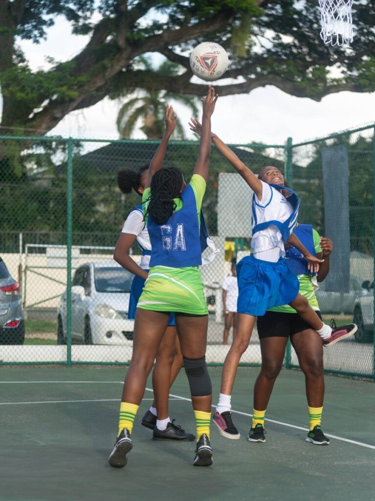 Hill Girls' Amelia Barton shoots while contested by a Cardinals defender in their Republic Bank Laventille Netball League beginners clash at the Lystra Lewis Netball Courts, Nelson Mandela Park, St Clair. - Photo by Dennis Allen for @TTGAMEPLAN