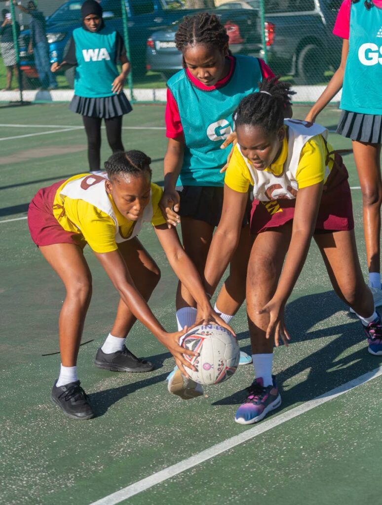 Players go for the ball in a Republic Bank Laventille Netball League match.
