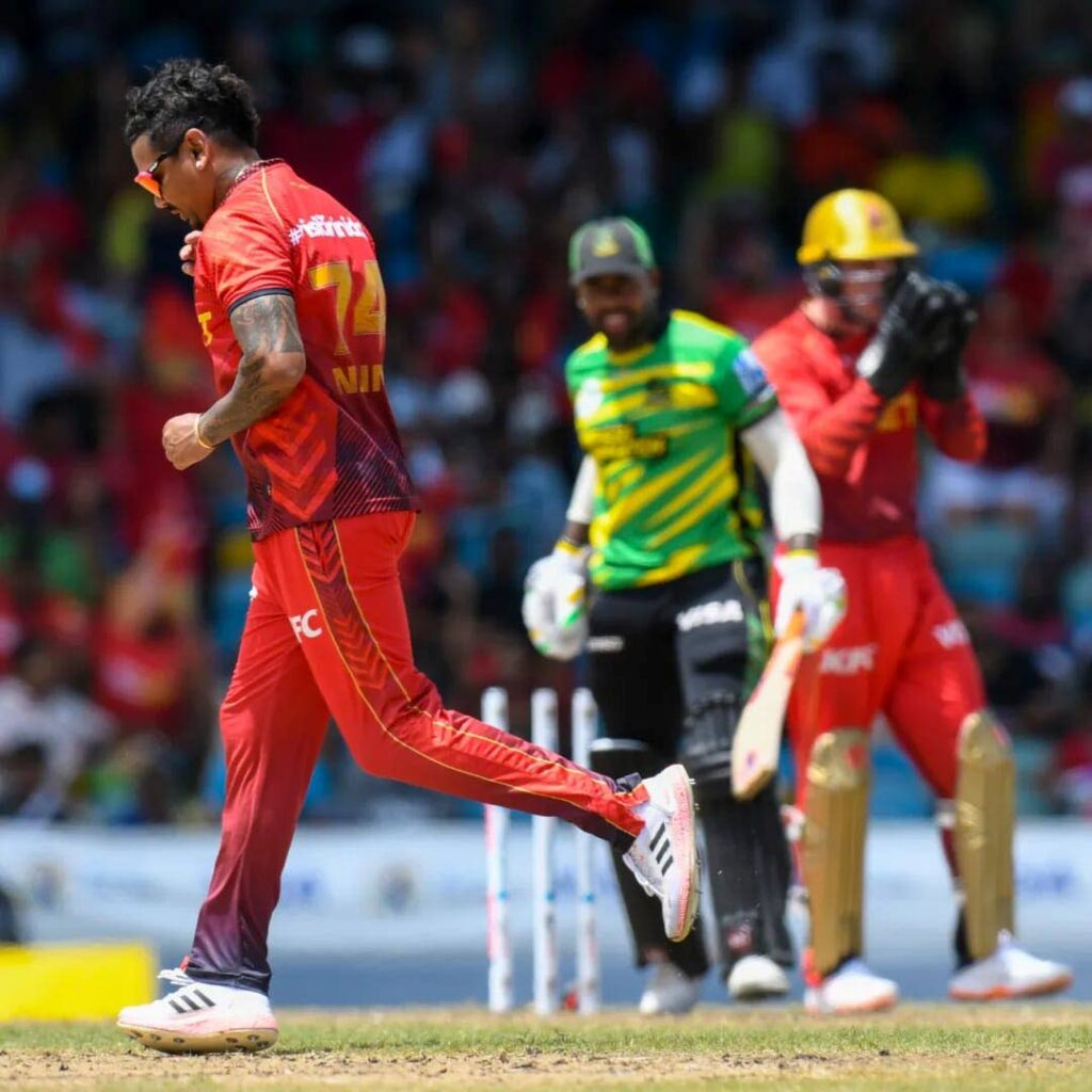 Trinbago Knight Riders spinner Sunil Narine, left, celebrates the dismissal of Jamaica Tallawahs' Fabian Allen in a Republic Bank CPL game at Kensington Oval, Barbados, Sunday. PHOTO COURTESY TRINBAGO KNIGHT RIDERS - 