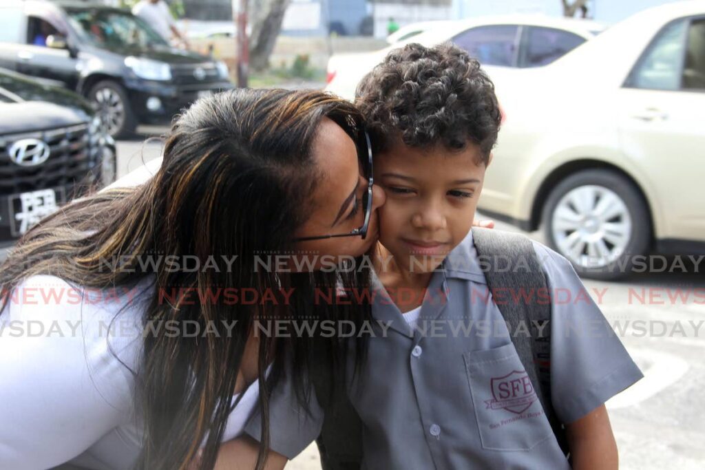 Dana St Laurent drops off her son, Nikolai at the San Fernando Boys RC school  at the start of the new school term. - Photo by Lincoln Holder