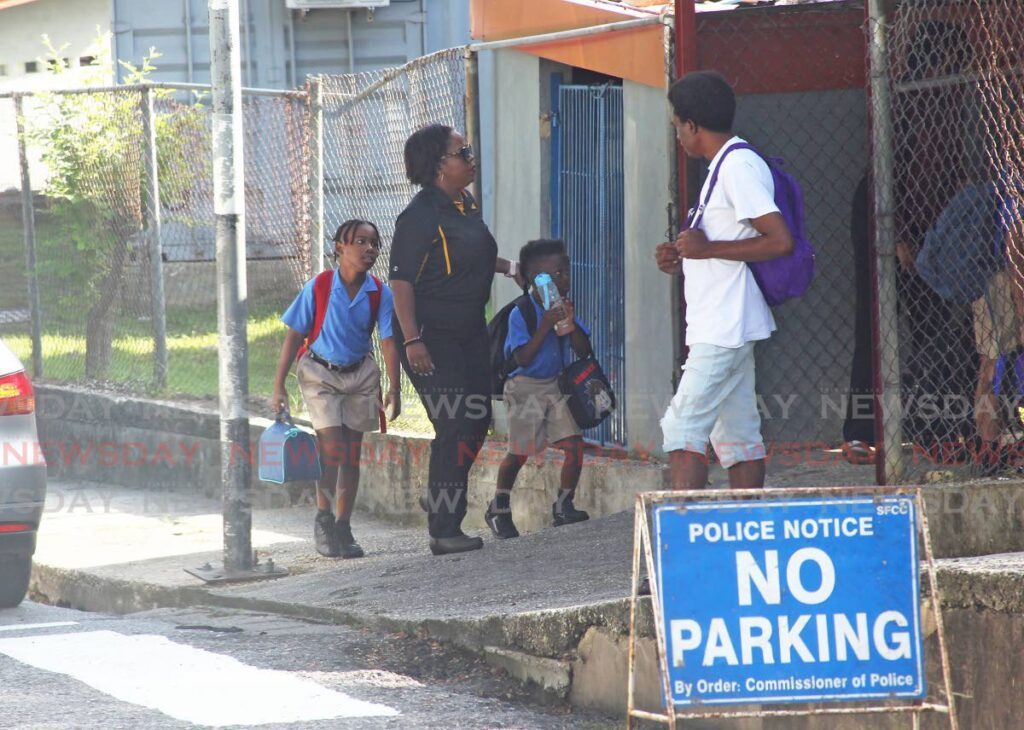 Students of the St Paul's Anglican school on Harris street San Fernando making their way to school at the start of the new school term.