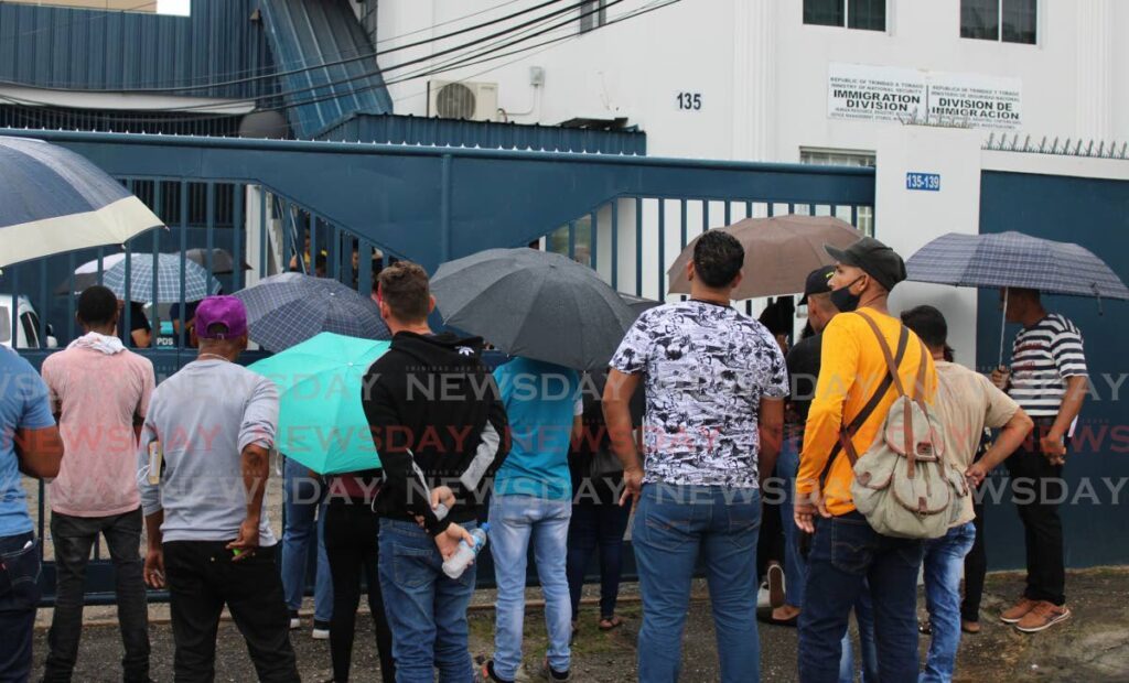 Hundreds of Venezuelans in front of the Immigration building on Henry St, Port of Spain waiting to update their work permits. - File photo by Grevic Alvarado