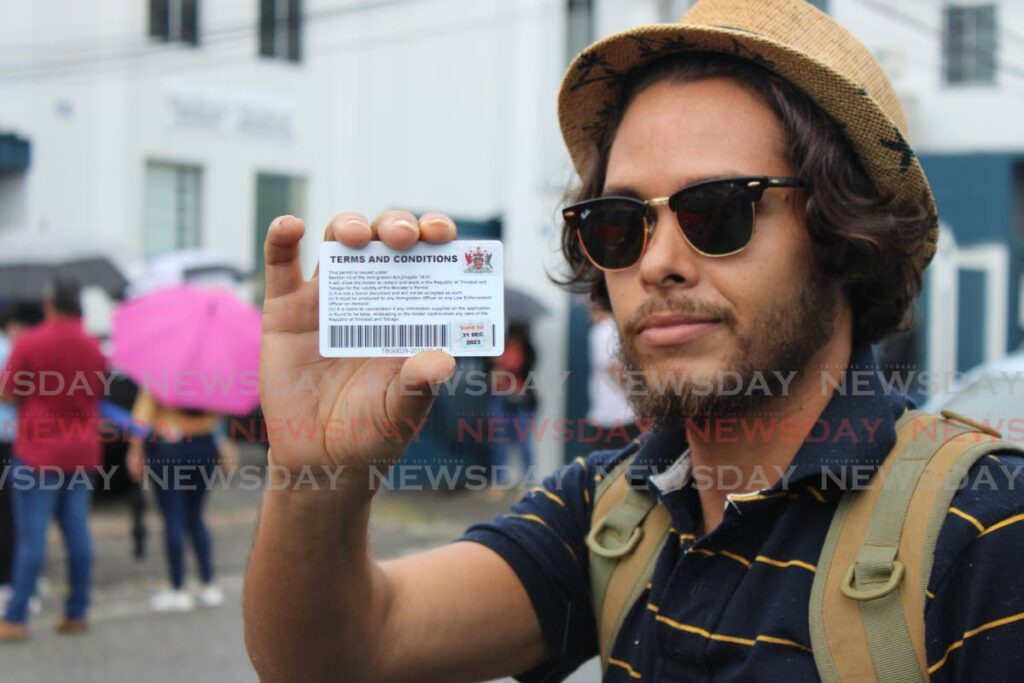 Venezuelan immigrant Carlos Luis Africano shows his registration card with the new sticker valid until December 31, 2023 - Photo by Grevic Alvarado