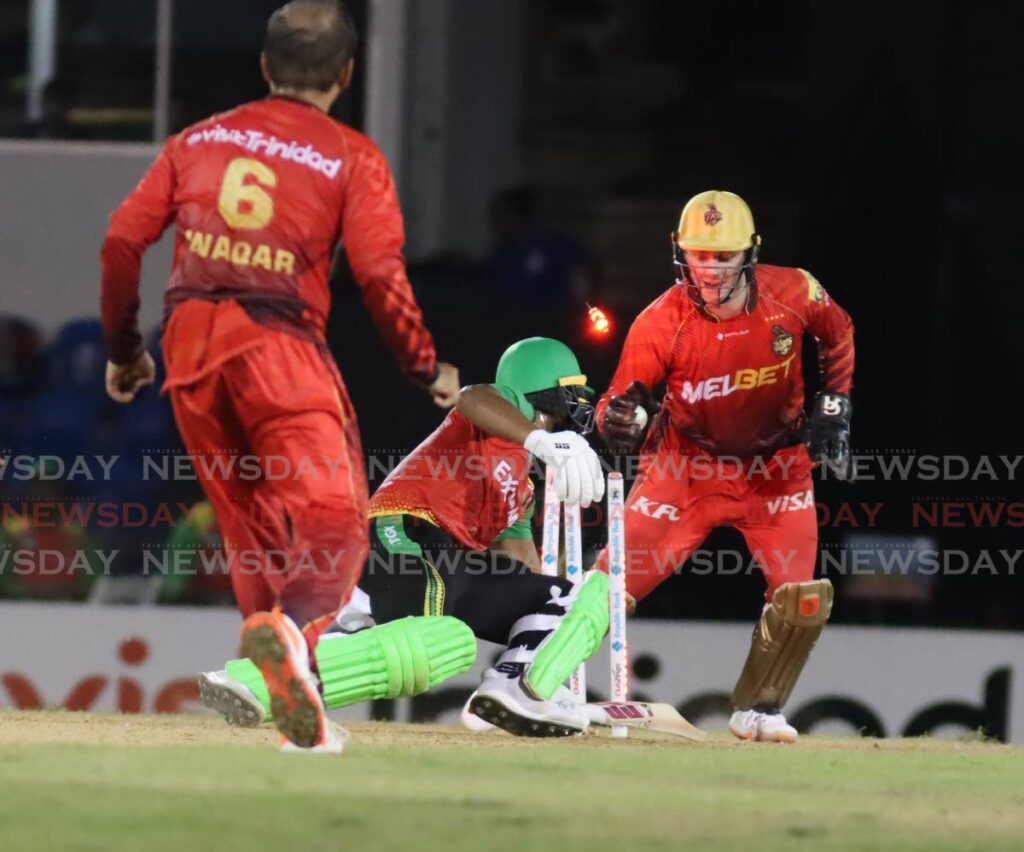 Trinbago Knight Riders wicketkeeper Lorcan Tucker attempts to steal the wicket of Amazon Warriors batsman Shai Hope, during the Republic Bank Caribbean Premier League T20 match, on Tuesday, at the Queen's Park Oval, St Clair. - Photo by Roger Jacob