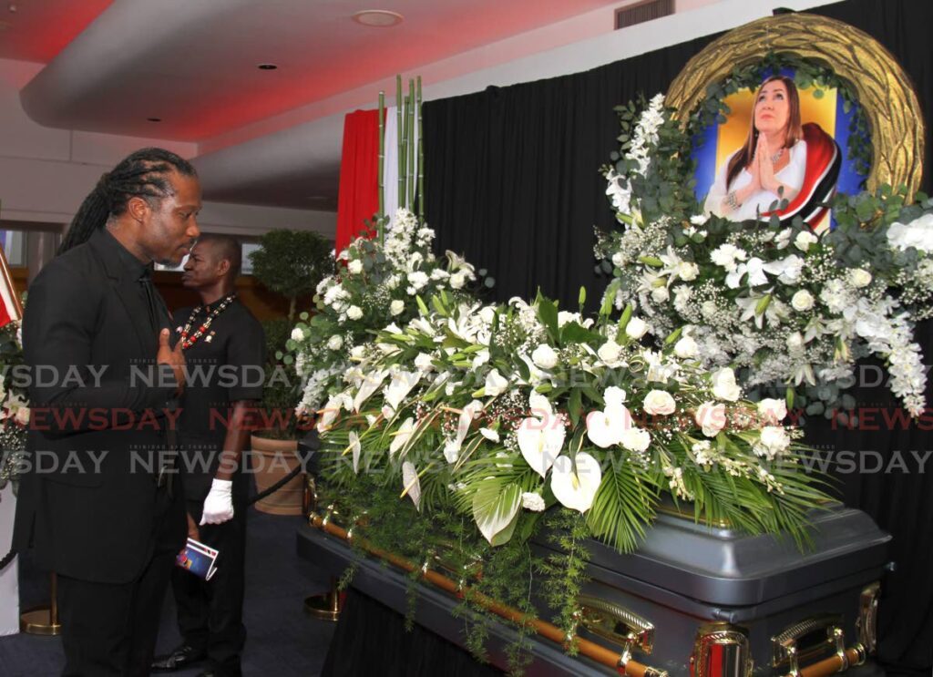Government minister Adrian Leonce pays his respects during the funeral of calypsonian Denyse Plummer at Queen's Hall, St Ann's on Thursday. - Photo by Ayanna Kinsale