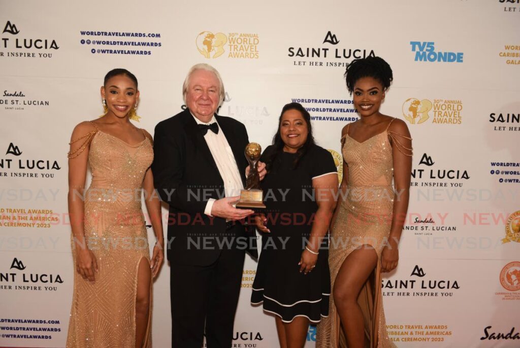 General manager of Amral's Travel Laura Baldeosingh Faucher (centre) poses for a photo with Graham Cooke, founder and president of World Travel Awards.
Amrals Travel won the award of TT's Leading Travel Agency for 2023. - Andrea De Silva