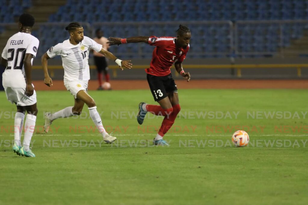 TT defender Ross Russell Jr (R) runs with the ball against Curacao during the Concacaf Nations League match, on Thursday, at the Hasely Crawford Stadium, Mucurapo.  - Roger Jacob 