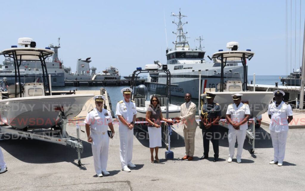 From left: US Embassy Senior Defense Official  Commander Richard Reyes, Commander US Naval Commander Rear Admiral James Aiken, US Ambassador Candace Bond, Minister of National Security Fitzgerald Hinds, TT Chief of Defence Staff Air Vice Marshall Darryl Daniel, and Acting Commanding Officer of the TT Coast Guard Commander Akenethon Isaac at a presentation of marine patrol and monitoring equipment from the US to TT at Staubles Bay, Chaguaramas, on Friday. - ROGER JACOB