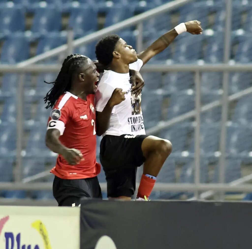 Trinidad and Tobago's Nathaniel James, right, pumps his fist after scoring the winner against Curacao in the Concacaf Nations League at the Hasely Crawford Stadium, Mucurapo, Thursday.  - TTFA