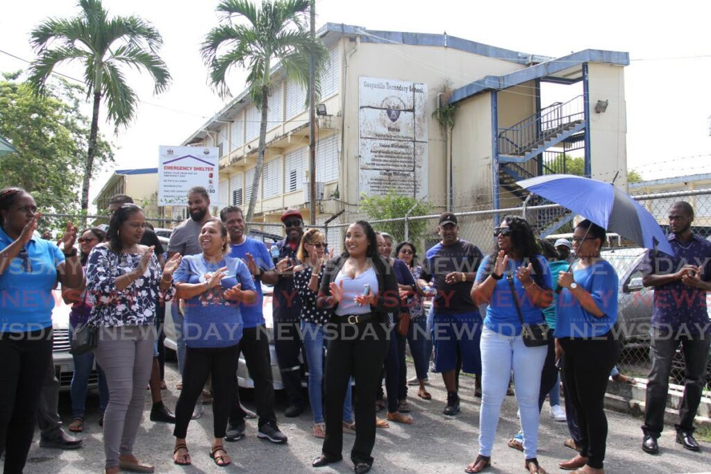Tabaquite MP Anita Haynes, centre, joins protesters outside the Gasparillo Secondary School, Gasparillo, last Friday. - AYANNA KINSALE