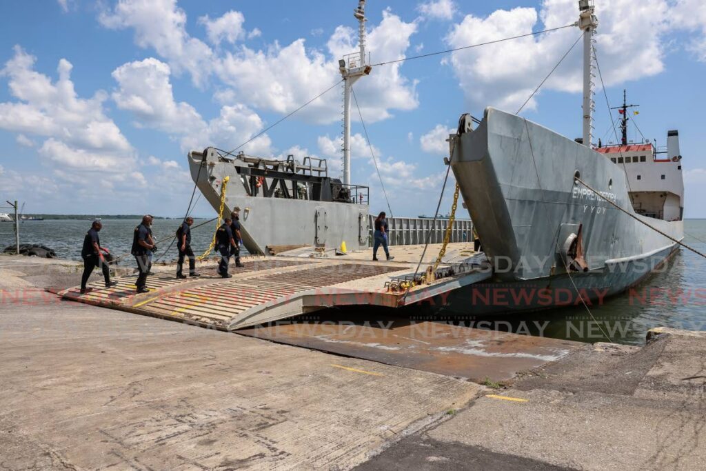 Customs officers board the Emprendedora after it docked at the Port of Spain harbour on Saturday. The vessel will be used to take cargo to Tobago as repairs are done to the Cabo Star.  - Jeff K. Mayers