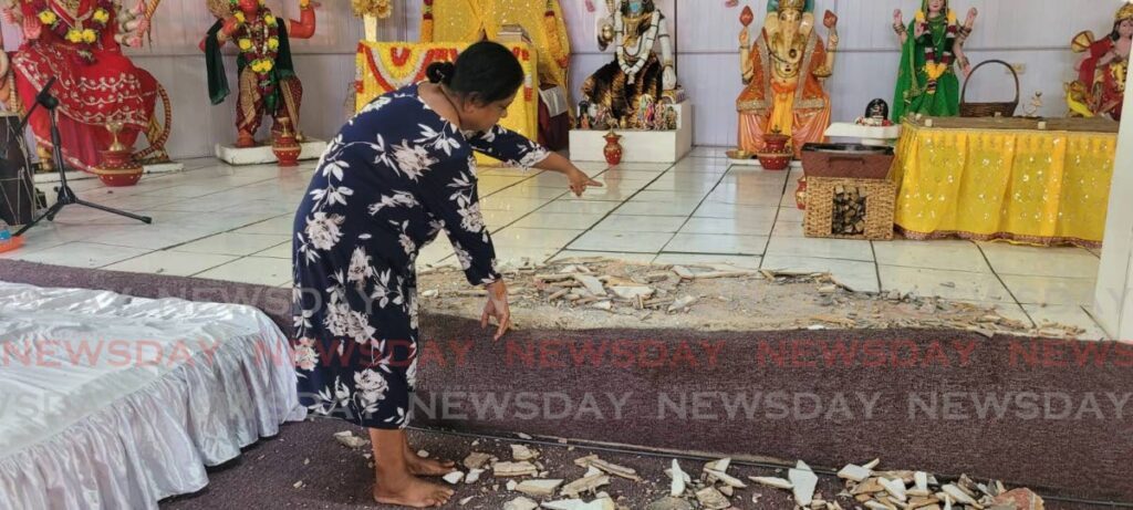 Vashti Sookhoo points to the damage done at the Williamsville Hindu Temple by vandals on the weekend.  - LAUREL V WILLIAMS 