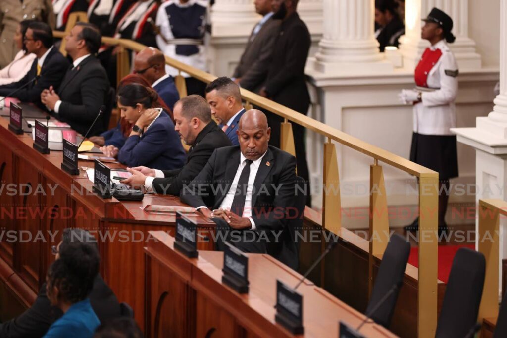 Anil Roberts sits with his back turned to President Christine Kangaloo in Parliament on Monday. - 