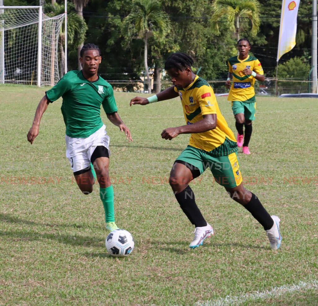San Juan North Secondary's Lindell Sween, left, and Malacai Webb of St Benedict's vie for the ball in a Secondary Schools Football League match, at the San Juan Secondary School Grounds, Bourg Mulatresse. - Photo by Roger Jacob