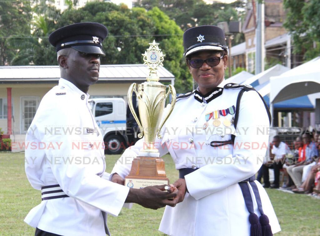 Commissioner of Police Erla Harewood-Christopher presents PC Waldron with hthe Commissioner of Police trophy during the TTPS Passing Out Parade at the Police Academy, St James Barracks, on Wednesday. - Ayanna Kinsale
