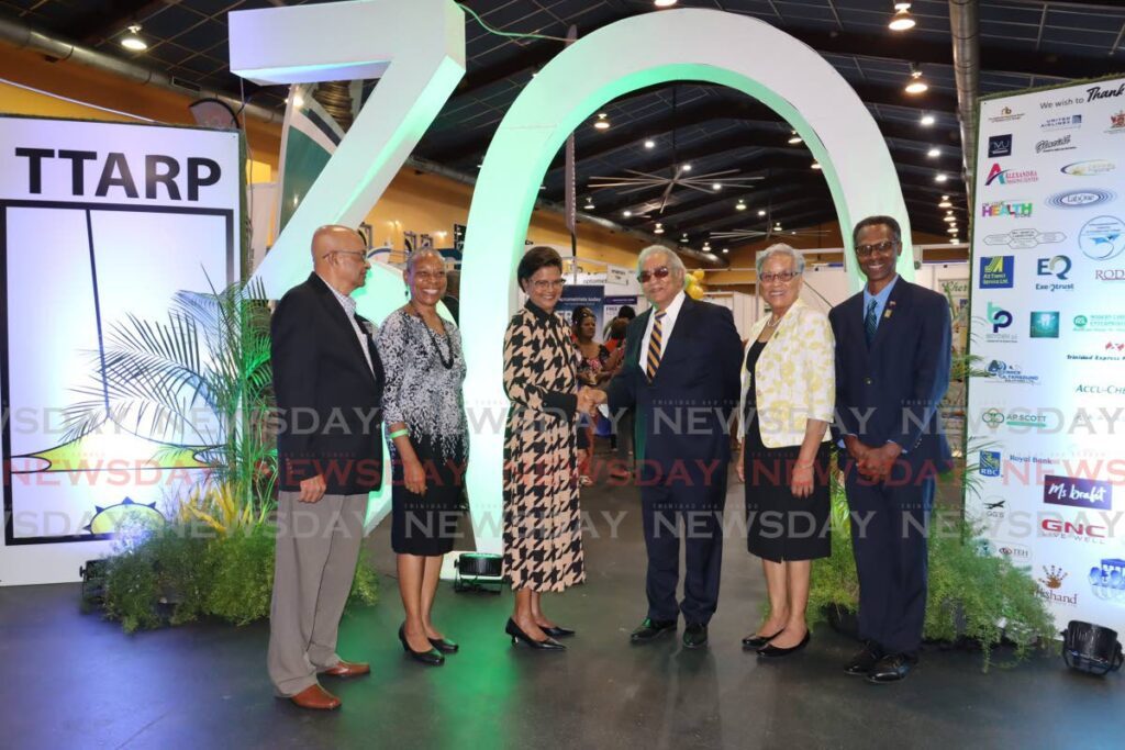 President Christine Kangaloo, third from left, greets president of TTARP Peter Pena and TTARP executive members, from left, Francis Raymond, Dr Jennifer Rouse, Maryling Younglao and Reynold Cooper as they celebrate TTARP's 30th anniversary and expo at the Centre of Excellence, Macoya, last Friday. - Photo by Roger Jacob