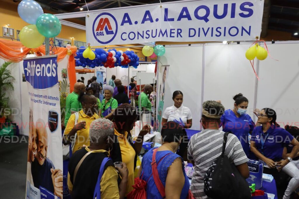 Retirees visit the AA Laquis booth at TTARP's 30th anniversary celebration and expo at Centre of Excellence, Macoya, last Friday. 