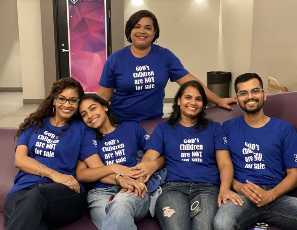 Attendees from In the River Ministries, Cocoyea, San Fernando, wearing T-shirts with the quote from the film, God's children are not for sale. - 