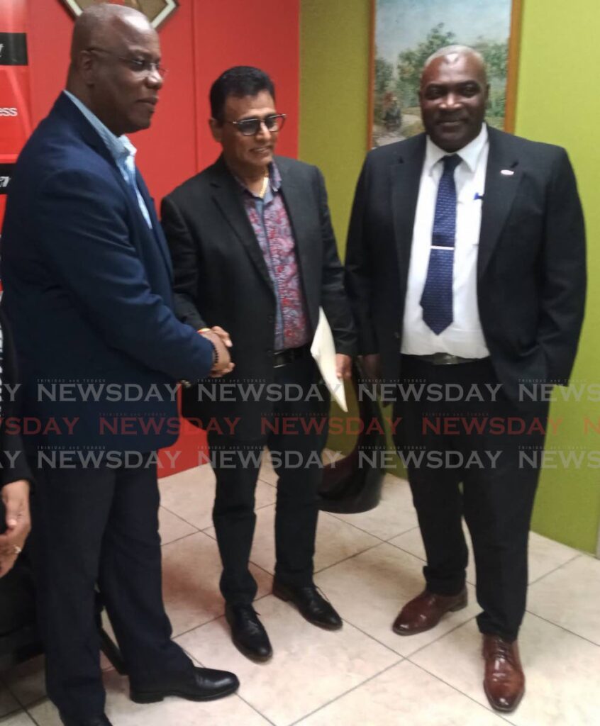 Tobago Chamber president Curtis Williams shakes hands with Works Minister Rohan Sinanan after a meeting at the chamber’s headquarters in Scarborough on Friday. Also in photo is former chamber head Demi John Cruichshank.  - PHOTO BY COREY CONNELLY
