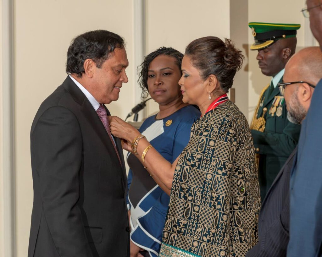 President Christine Kangaloo pins the Chaconia Gold medal on businessman Sieunarine Coosal at the national awards ceremony at President's House on Sunday. - Photo courtesy office of the President