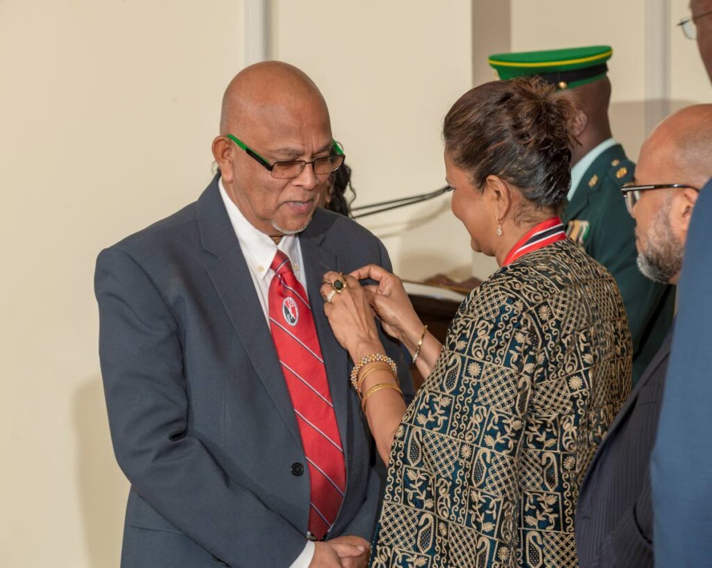 President Christine Kangaloo (R) presents Trinidad and Tobago Cricket Board president and Cricket West Indies vice president Azim Bassarath with the Hummingbird Medal Gold, on Sunday, at the national awards ceremony held at President's House, St Ann's.  - Photo courtesy Office of the President