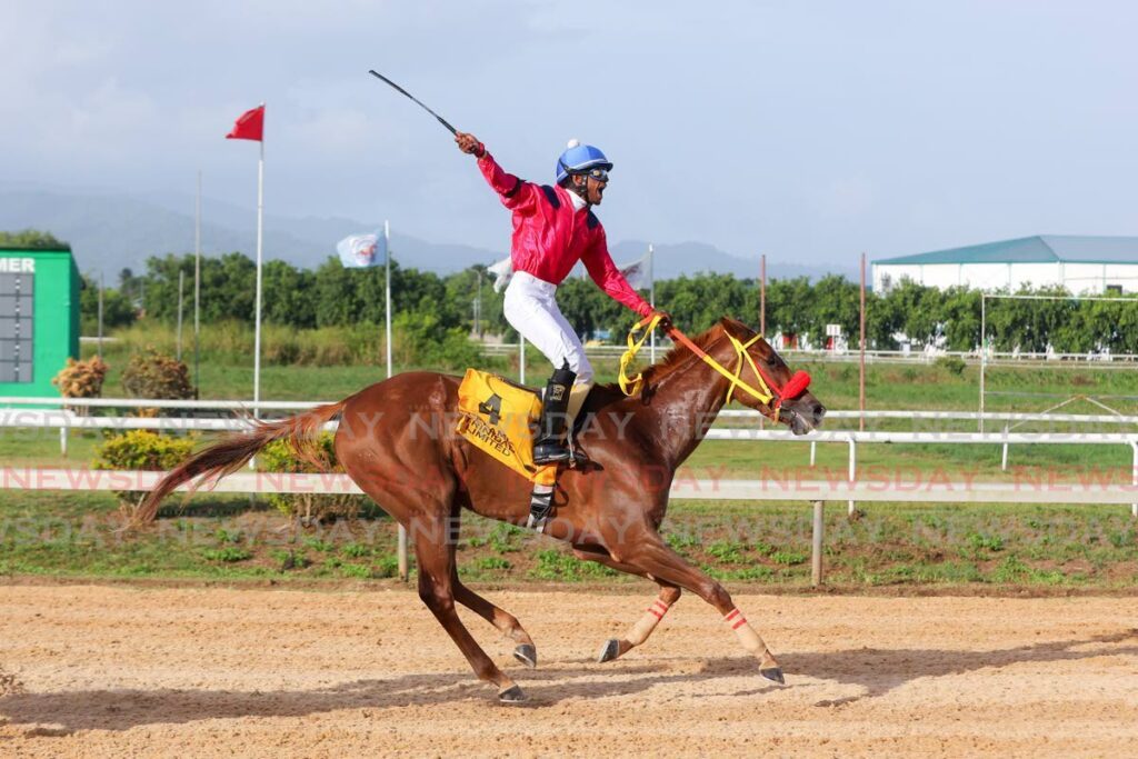 Jockey Niam Samaroo, riding In The Headlines, celebrates after winning the Trinidad Derby Stakes at the Santa Rosa Park on Monday at the Arima Race Club, Arima. - Daniel Prentice 