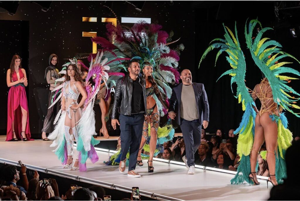 Shane Ramnaine and business partner Luca DiBerardino walk the runway during the finale of the 11 Threads Roma fashion show. - 