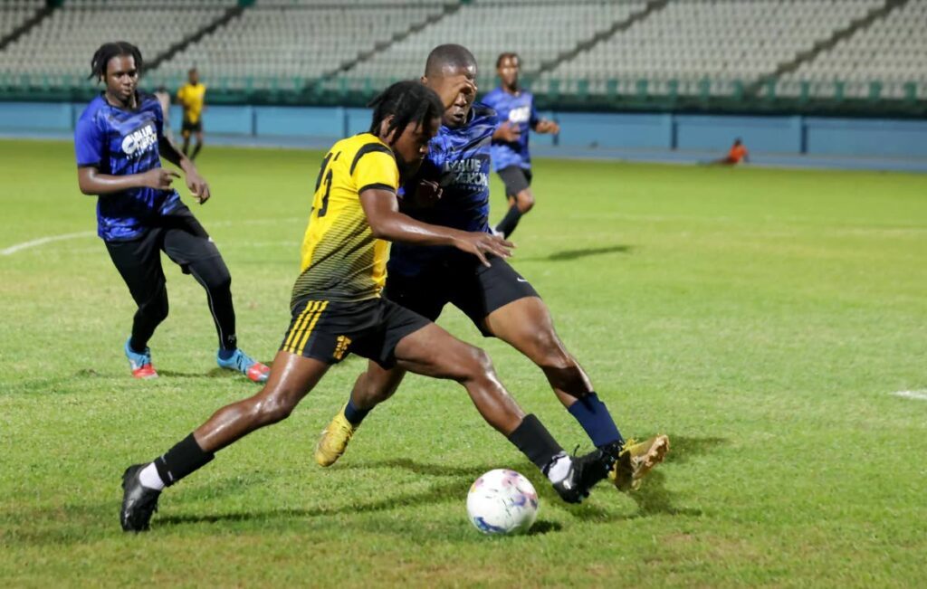 A Sidey's FC player shields the ball from his Golden Lane opponent in the TFA knockout semis on Saturday. - 