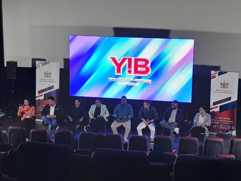 The team of panellists engage in discussion during the Ministry of Sports and Community Development's Youth in Business Symposium at Movie Towne PoS on September 22.  - Roneil Walcott