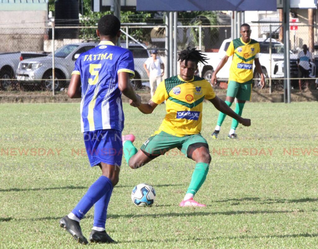 St Benedict’s College player Josiah Ochoa (C) looks to kick the ball during the Secondary Schools Football League Premiership Division match, on Wednesday, at Fatima Grounds, Mucurapo. The match ended 0-0.  - Ayanna Kinsale