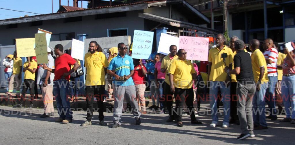 PRIORITISE WORKERS: Daily paid workers at the San Fernando City corporation stage an early morning protest outside their Carib Street San Fernando garage to highlight poor working conditions. -Photo by Lincoln Holder